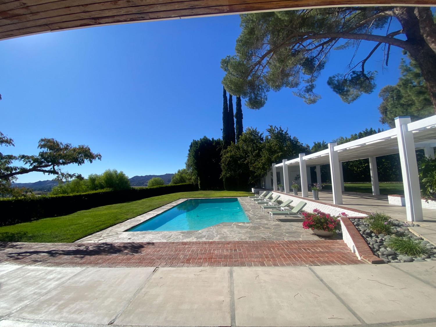 Swimming pool with covered outdoor entertaining area and mountain views