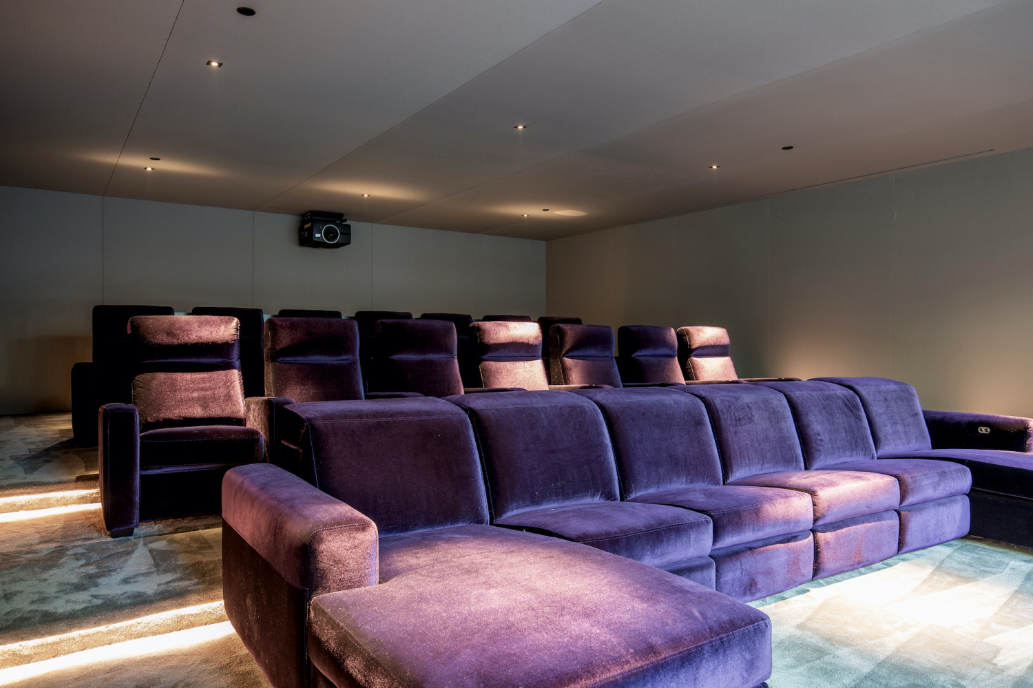 Private screening room with plush theater seating for presentations, entertainment, and executive gatherings.