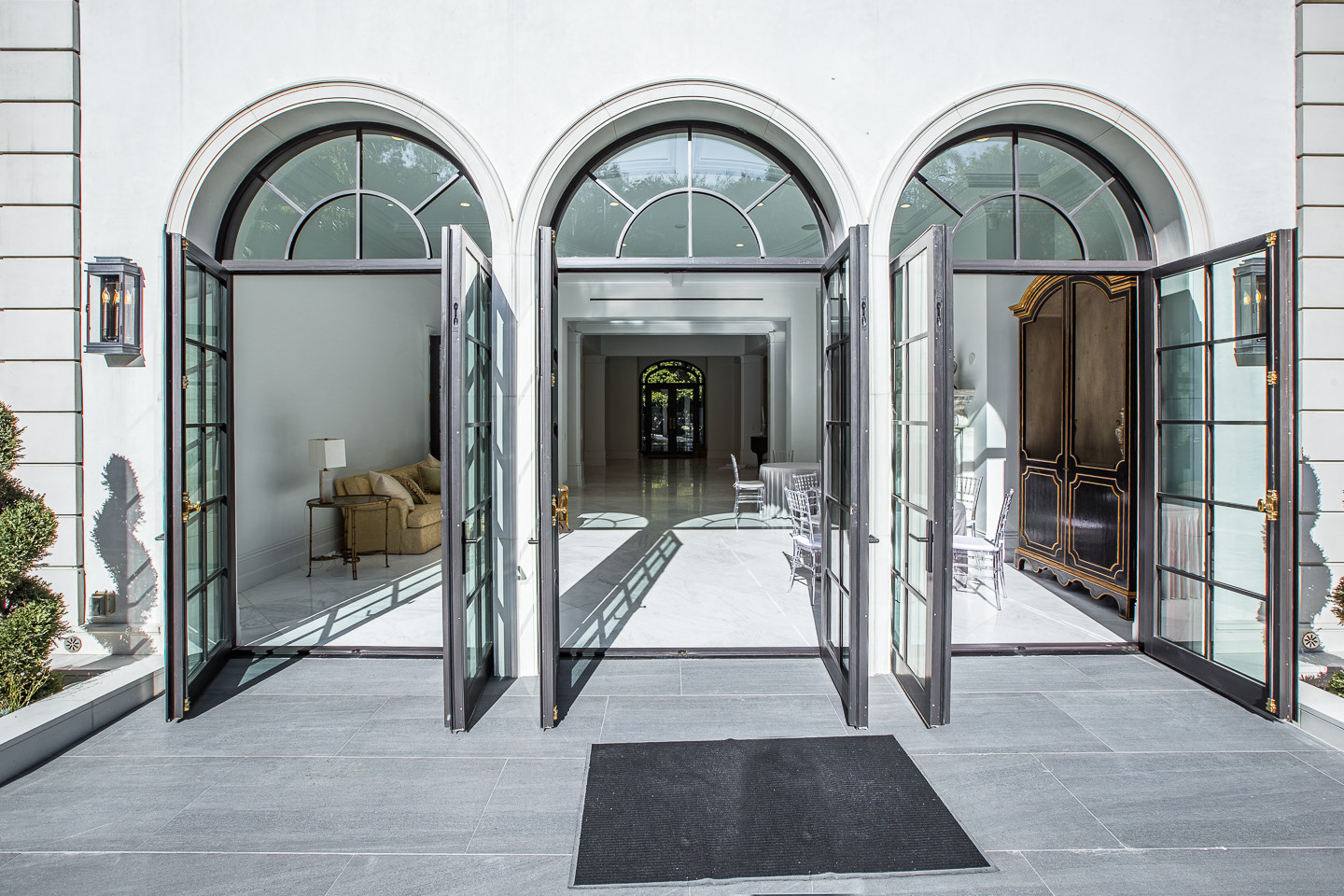 Bright great room with floor-to-ceiling sliding glass doors opening to the gardens of a luxury Los Angeles estate rental.