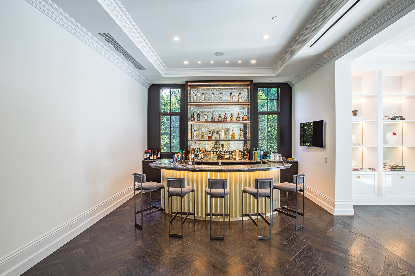Custom entertaining bar with illuminated shelving inside a luxury Los Angeles private estate for corporate events and celebrations.