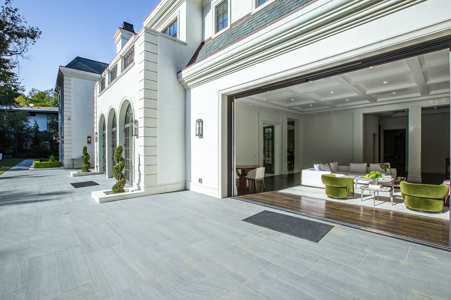 Expansive indoor-outdoor terrace connecting the great room to the private gardens at this Los Angeles event estate.