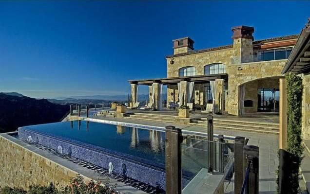 Tuscan-inspired Malibu vineyard estate with an infinity pool, expansive terraces, and breathtaking mountain views.