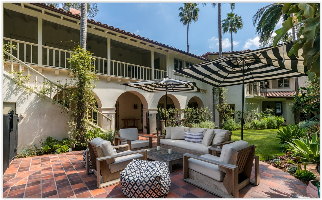 Inviting Spanish-style courtyard with comfortable lounge seating and mature landscaping at a Los Feliz private estate.