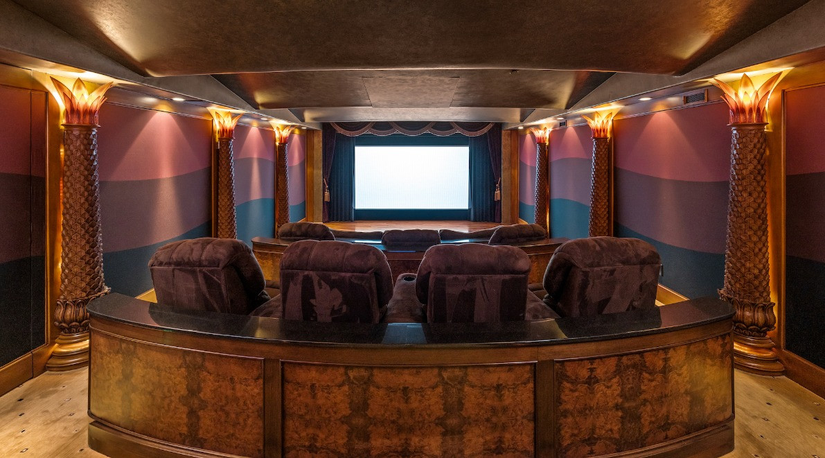 Luxury home theater with tiered seating designed for private screenings and entertainment.