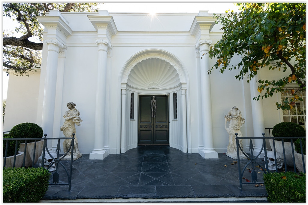 Classical front entrance with grand columns and elegant architectural detailing at a Beverly Hills estate.