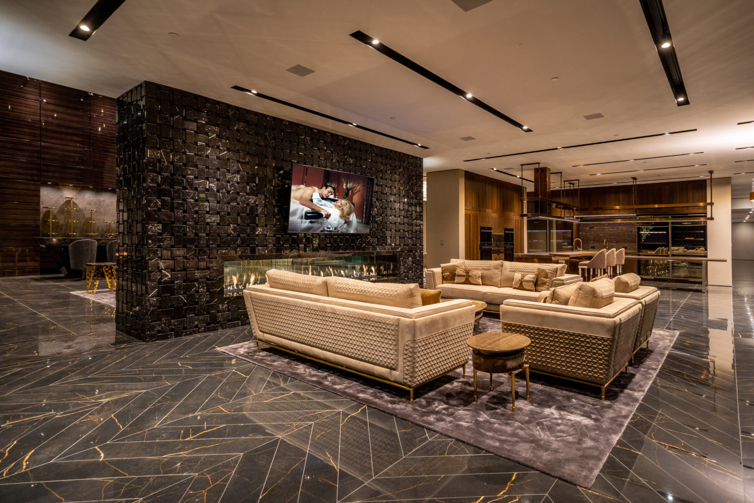 Luxury Bel Air estate featuring a dramatic great room with designer fireplace, contemporary furnishings, soaring ceilings, and seamless indoor-outdoor living.