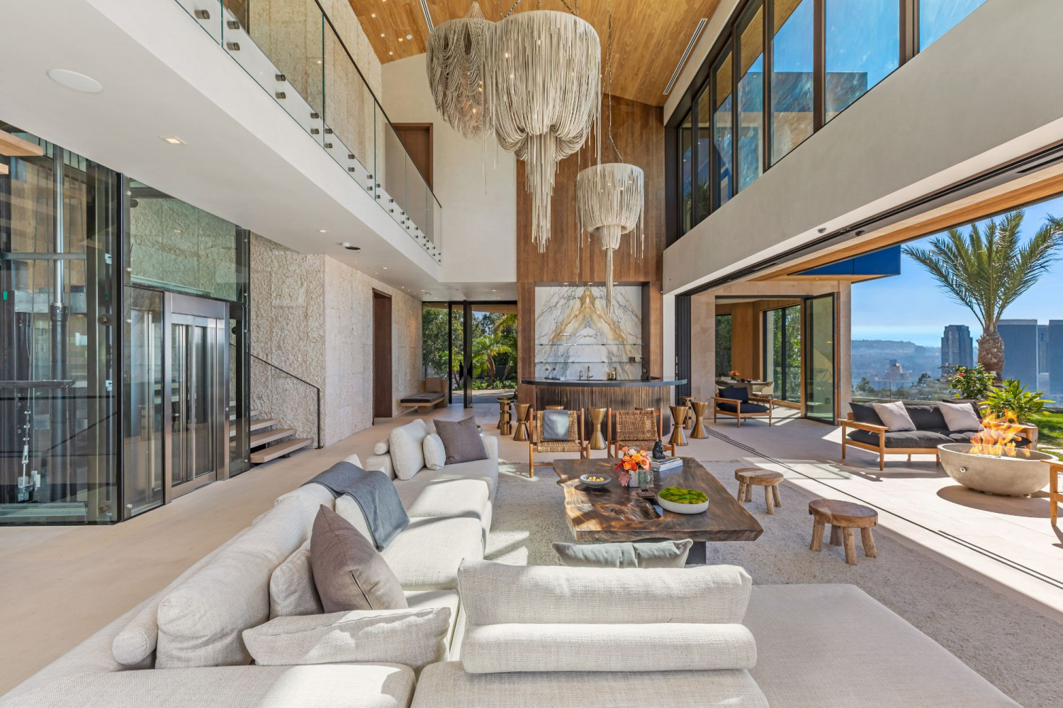 Bright contemporary great room with floor-to-ceiling windows overlooking Beverly Hills.