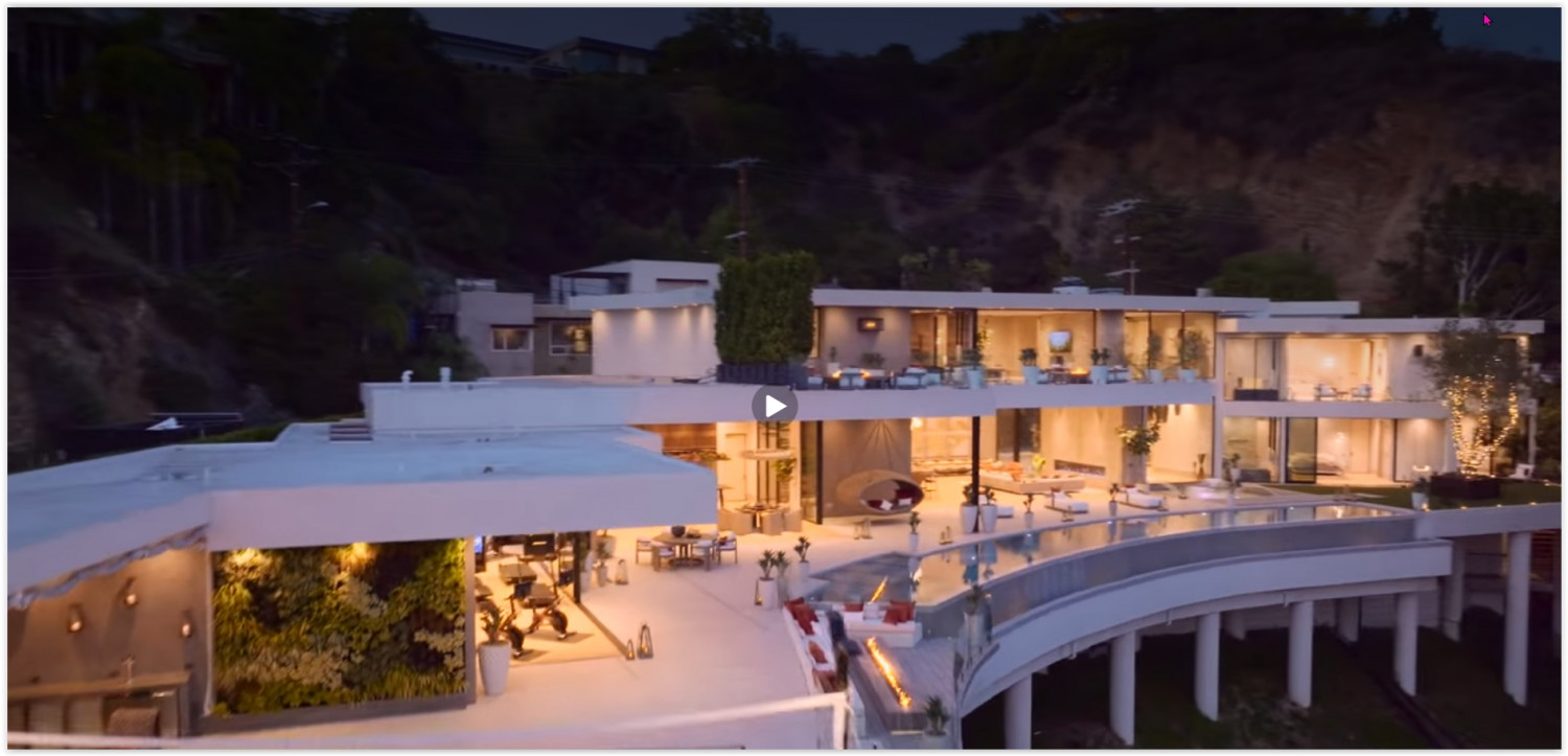 Modern Los Angeles estate with infinity pool, multiple entertaining levels, and panoramic city views at twilight