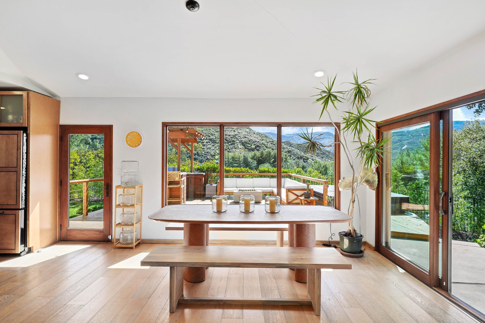 Open-concept living and dining room with vaulted ceilings and abundant natural light.