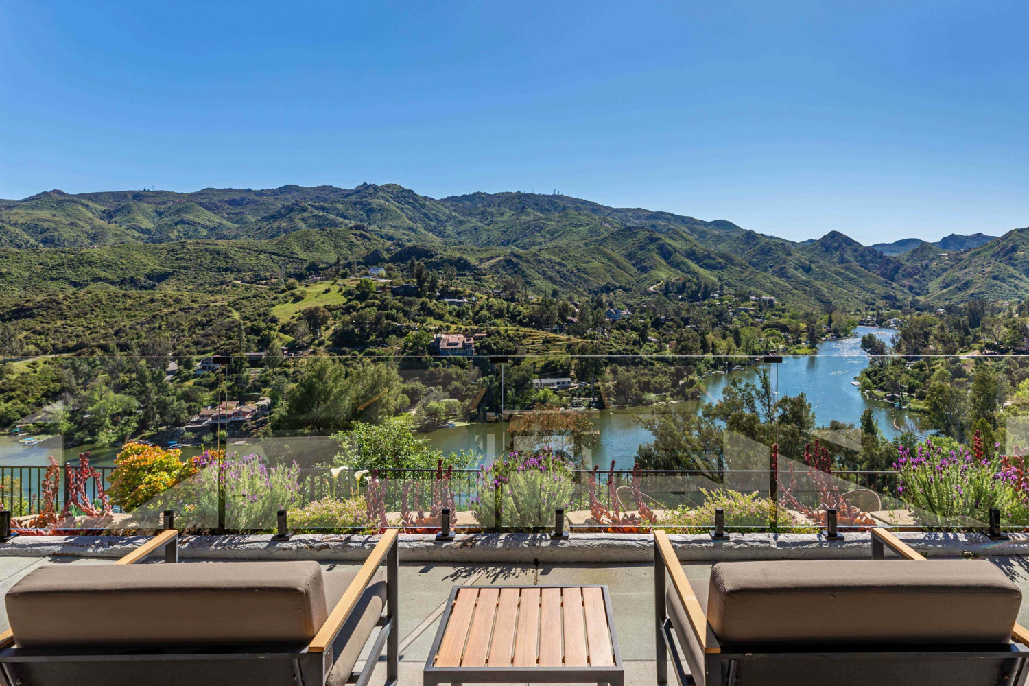 Outdoor rooftop terrace with lounge seating and bar area overlooking dramatic mountain and canyon views in Agoura Hills.