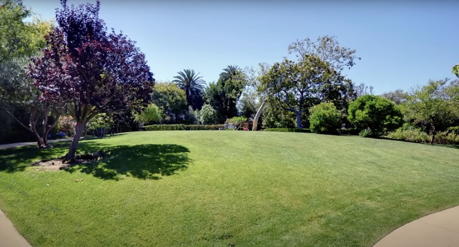 Expansive manicured lawn at a luxury estate for exclusive events.