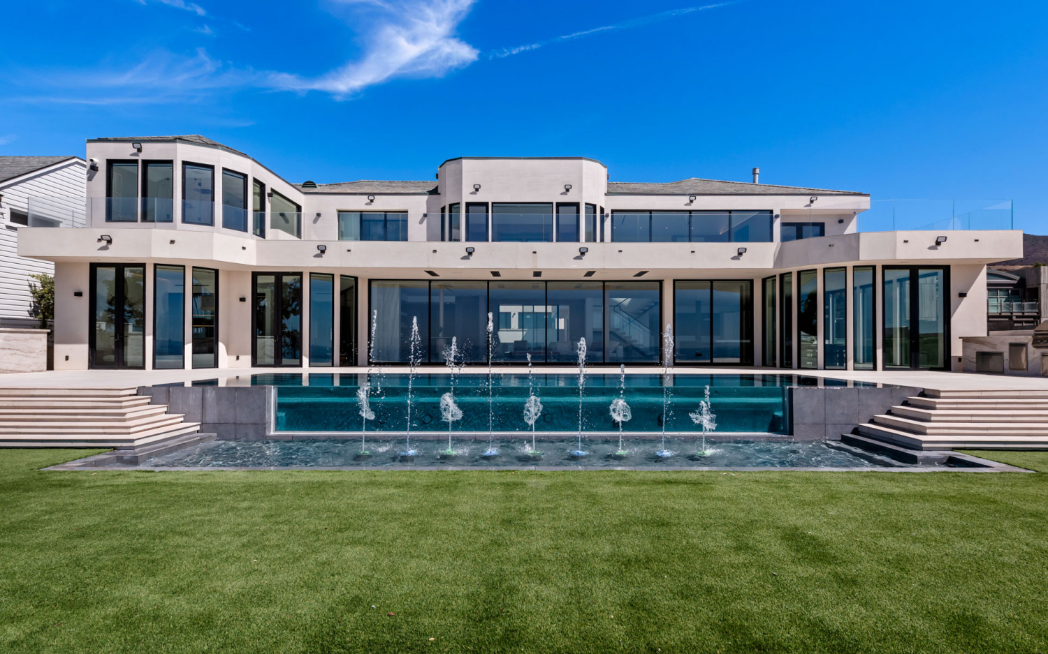 Infinity pool with water features at Malibu beachfront estate