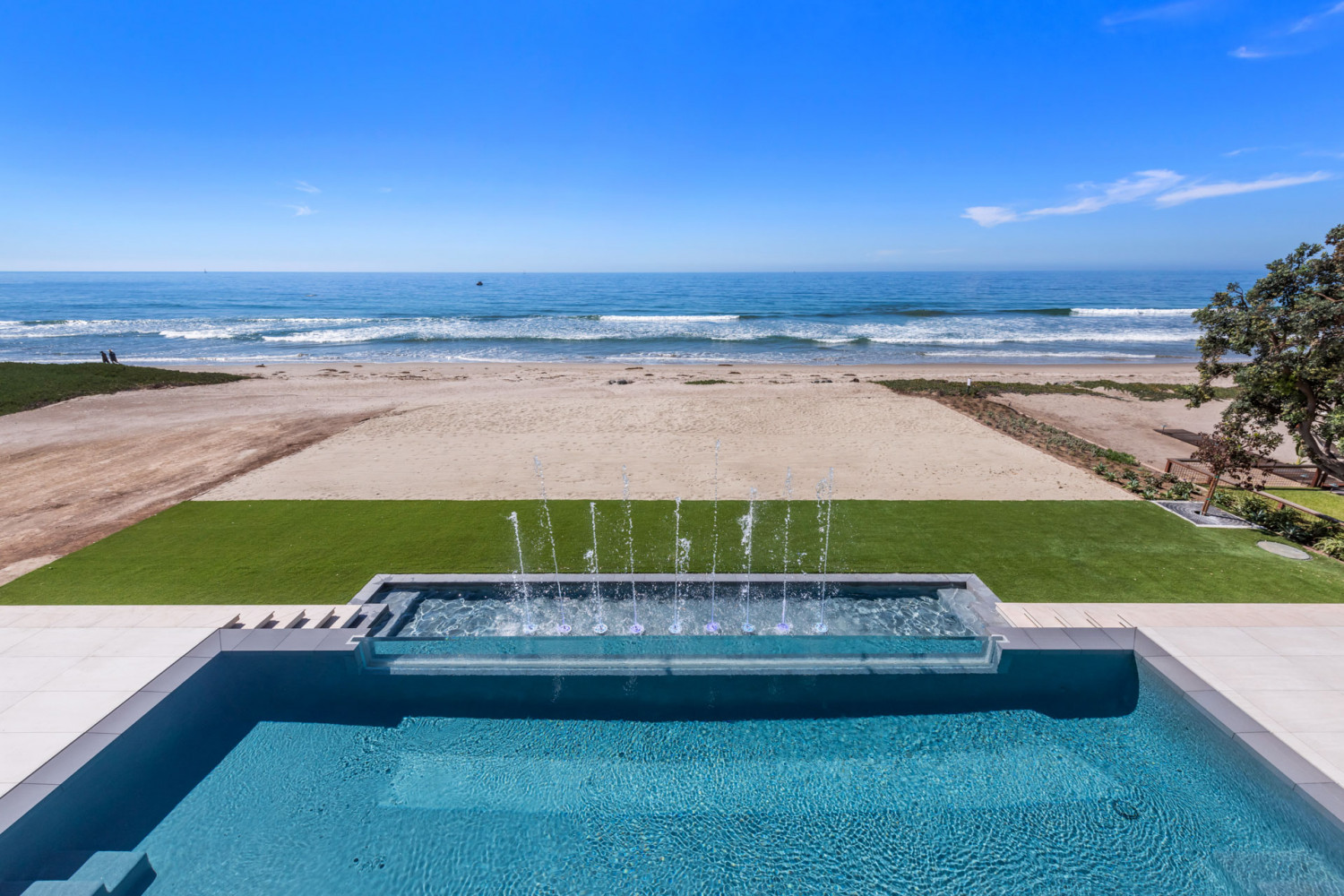Infinity pool with water features at Malibu beachfront estate