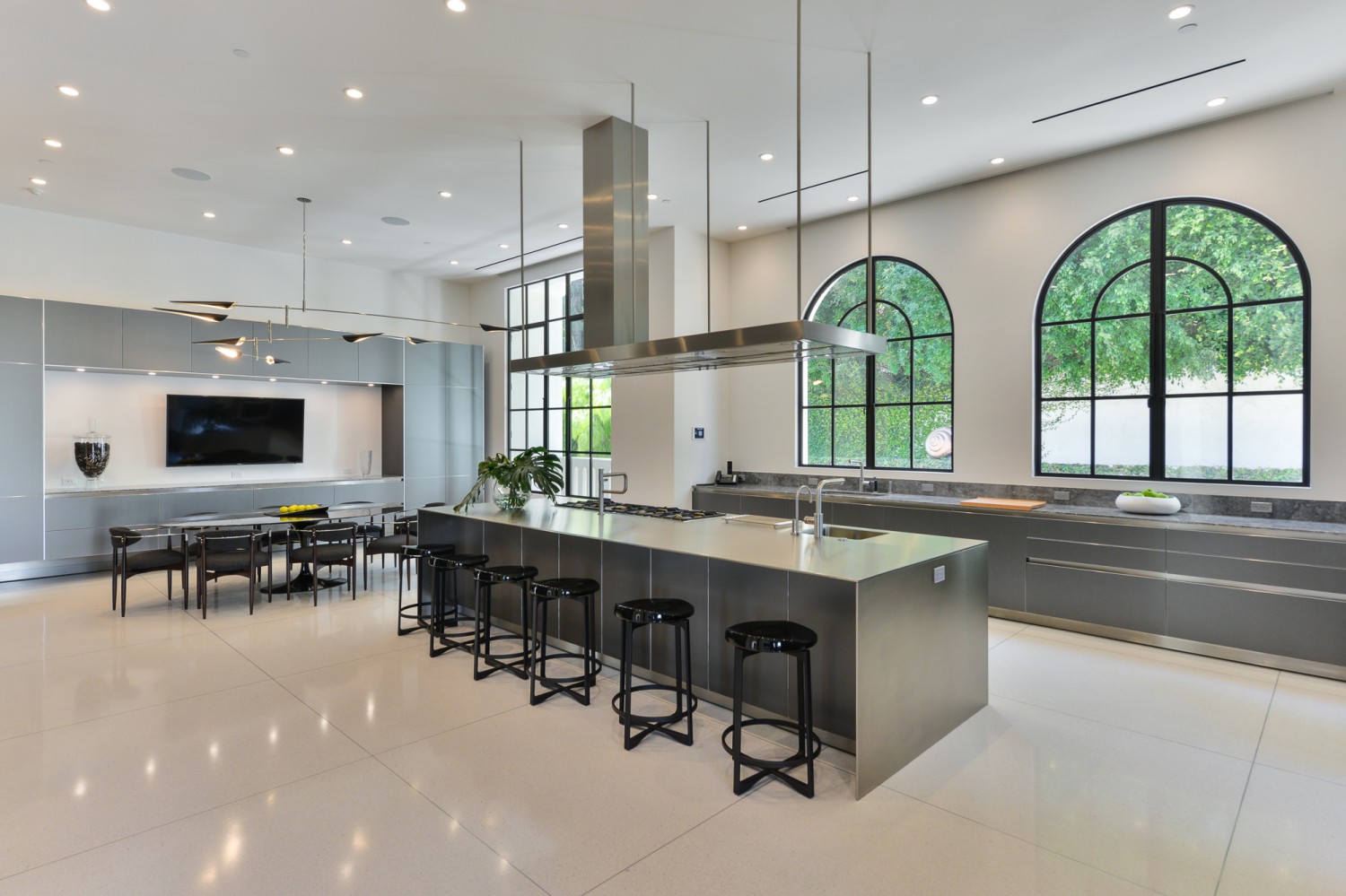 Contemporary chef’s kitchen with large island, black-framed windows and modern cabinetry