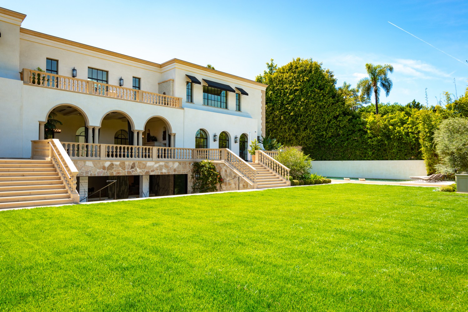 Bel Air estate with expansive manicured lawn, elegant architecture and outdoor entertaining space