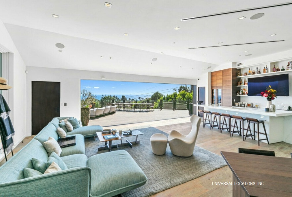 Spacious great room opening to an ocean view entertaining terrace at a luxury Malibu estate.