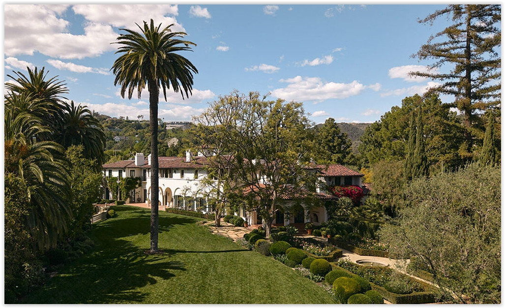 Mediterranean Bel Air estate with arched colonnade, lawn and mature landscaping