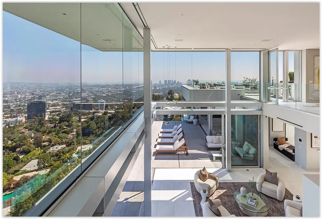 Modern glass-walled Los Angeles estate interior with panoramic city views and indoor-outdoor entertaining spaces
