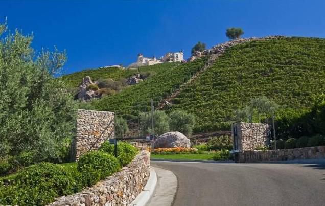 Stone exterior and landscaped approach at a private Malibu estate
