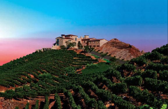Wide view of Malibu private estate surrounded by mountain and canyon scenery at sunset
