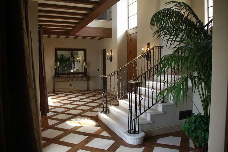 Elegant private estate entry with sweeping staircase and warm architectural details