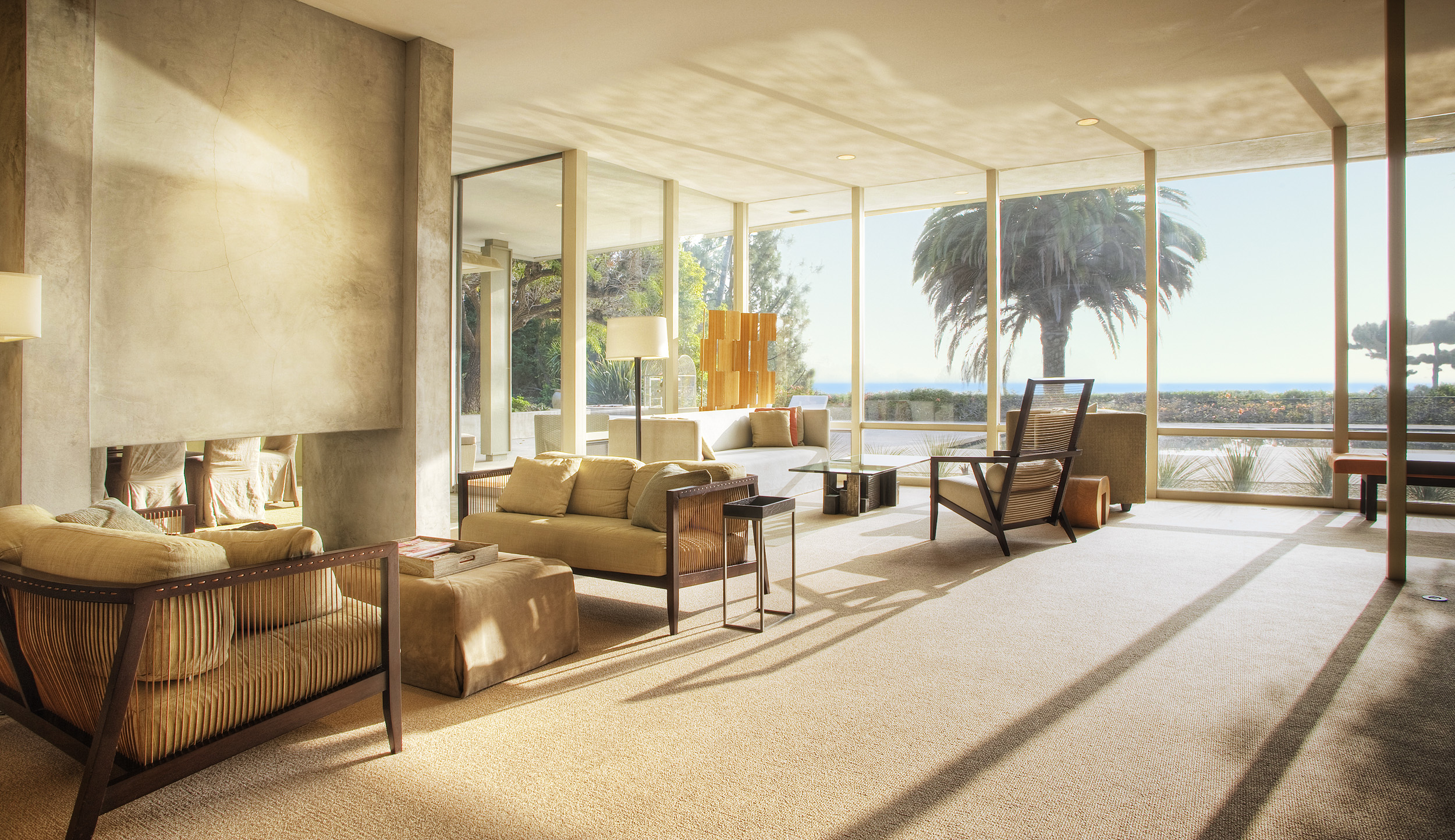 Mid-century Beverly Hills living room with floor-to-ceiling windows and garden views