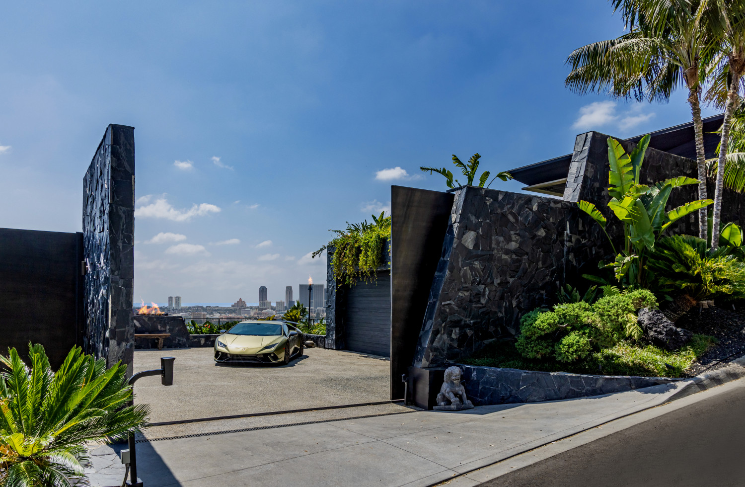 Gated entrance to modern Los Angeles private estate with tropical landscaping