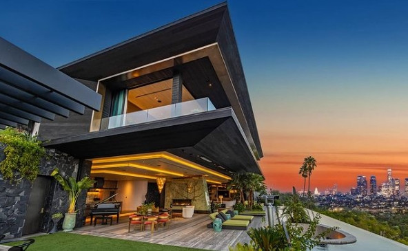 Modern Los Angeles estate with open-air terrace and city skyline at sunset