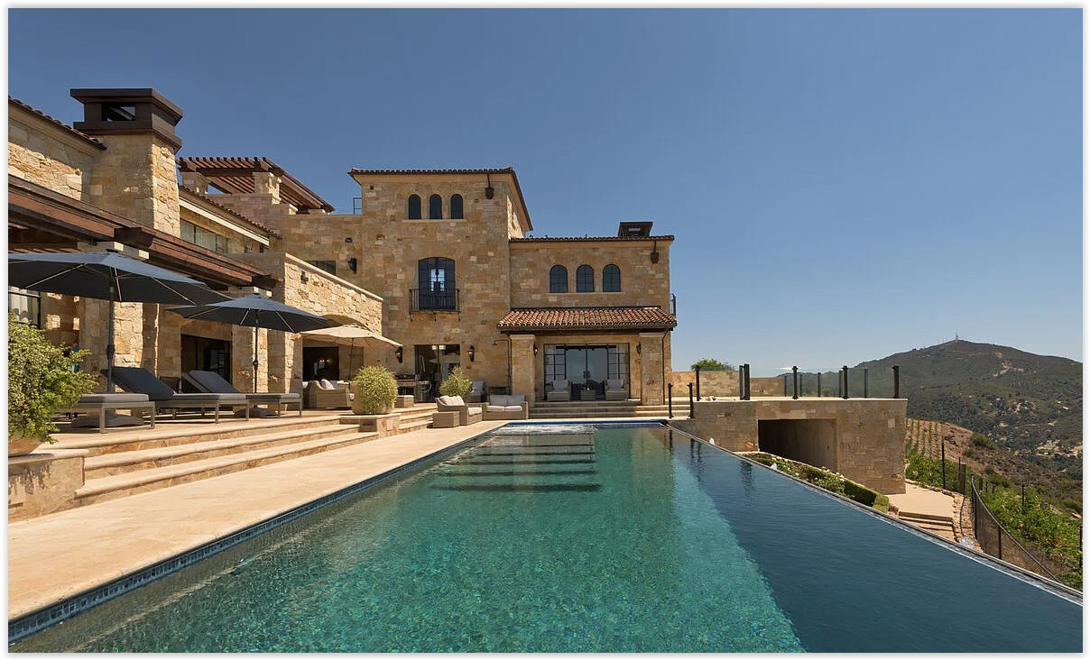 Daytime infinity pool and outdoor terrace at Malibu private estate
