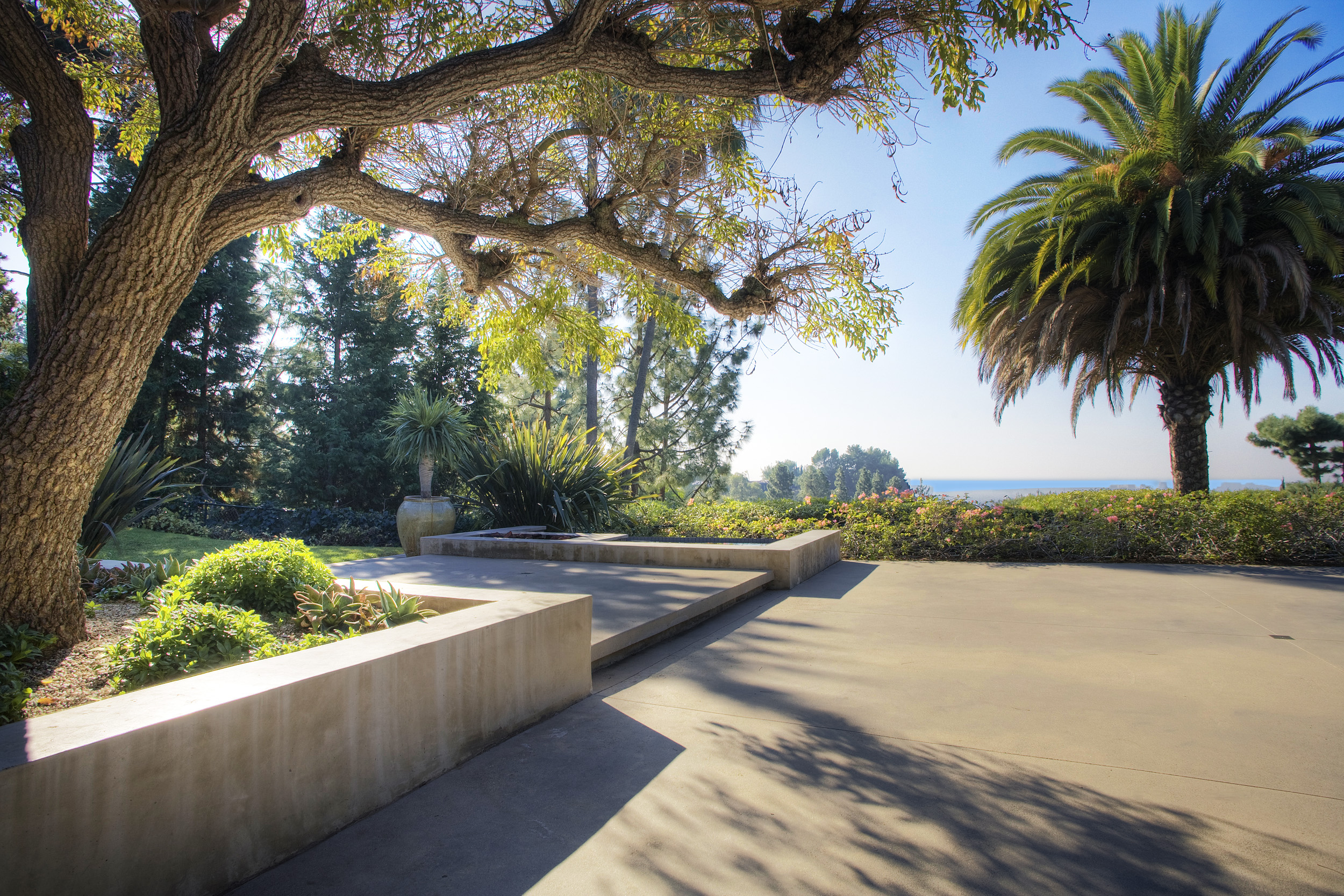 Outdoor patio with palm tree and distant views at Beverly Hills estate