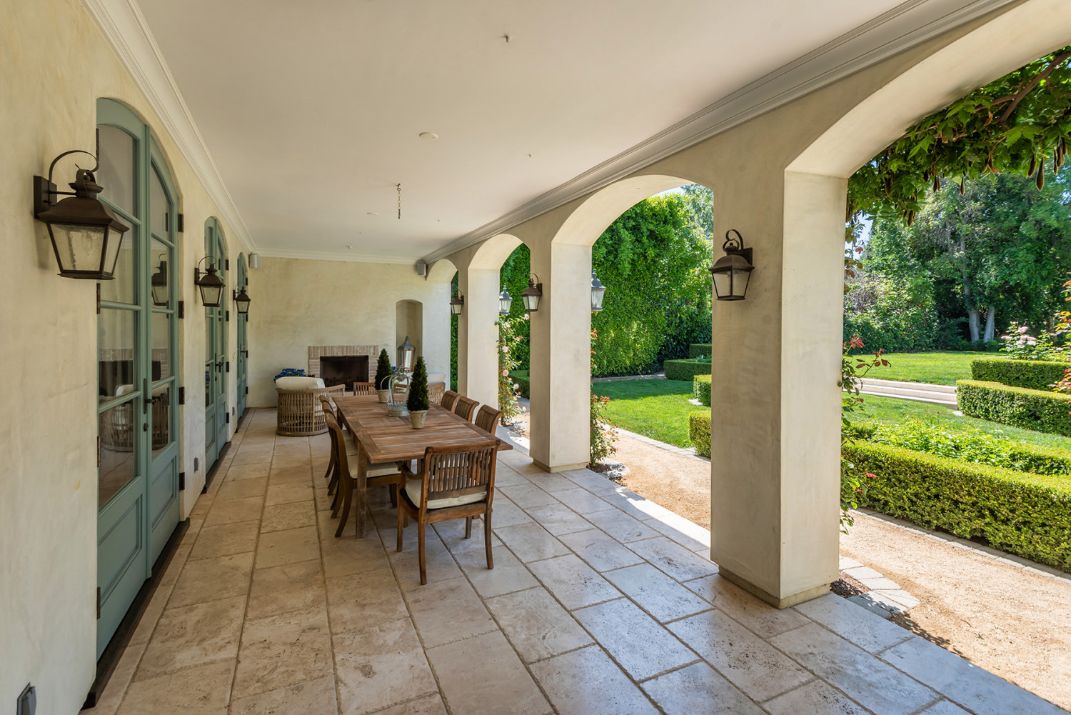 Covered terrace with outdoor dining furniture overlooking the garden