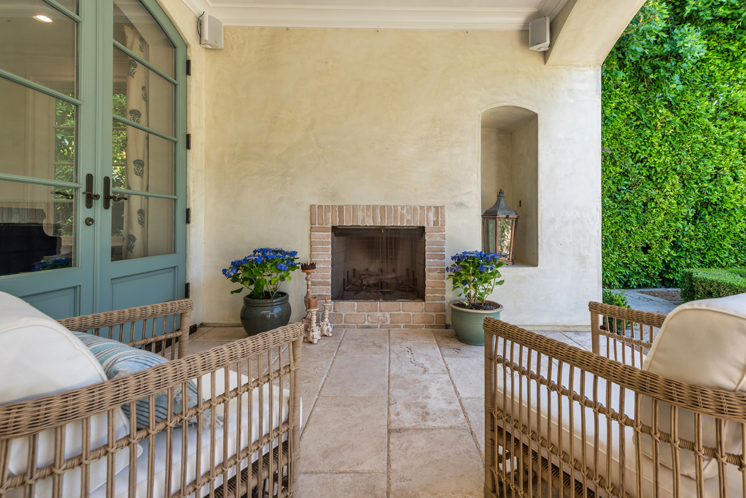 with Outdoor Fireplace Outdoor fireplace and seating beneath the estate’s covered terrace